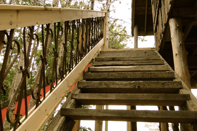 Treehouse steps with reclaimed iron railing