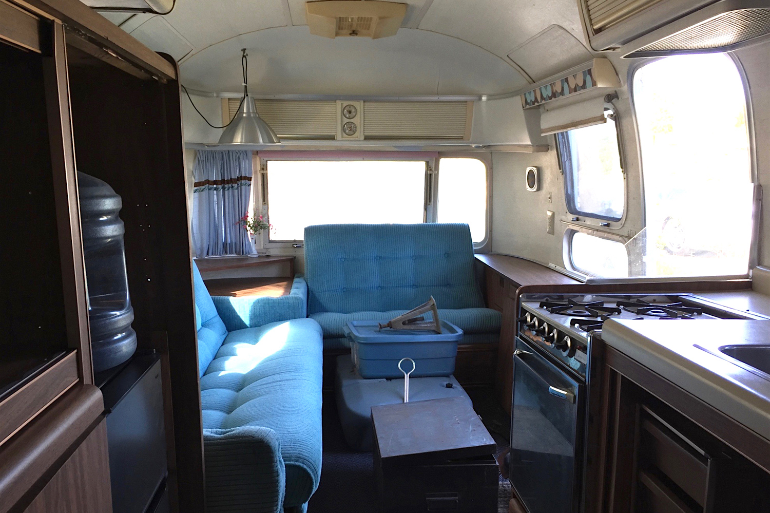 The before photo of a 1976 vintage airstream, transformed with white paint, gold accents and gorgeous home decor. A must see! Click on the photo to see more. Airstream by Lynne Knowlton from Design The Life You Want to Live www.lynneknowlton.com